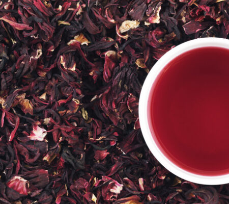 Cup of hibiscus tea on the leaves, panorama